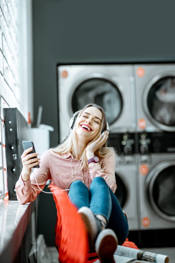 Woman waiting in the self-service laundry